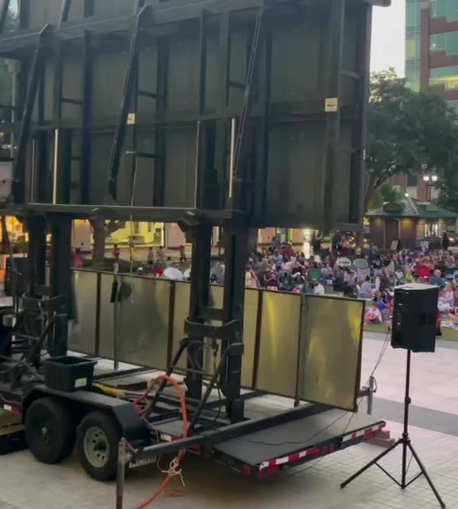 SkyLit Events LED screen trailer set up for an outdoor crowd